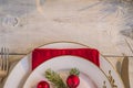 festive table setting for christmas dinner/whte plates,red napkin,vintage cutlery on light wooden background with copy space Royalty Free Stock Photo