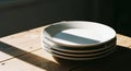 White plates stacked on wooden table Royalty Free Stock Photo