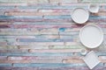 White plates and vintage spoons and fork on color wooden background Royalty Free Stock Photo