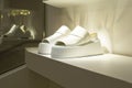 white platform sandals spotlighted on a clean, modern shelf