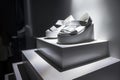 white platform sandals spotlighted on a clean, modern shelf