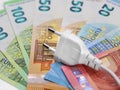 white plug on euro banknotes, concept of electricity price increase