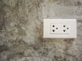 White plug socket on the Cement wall Royalty Free Stock Photo