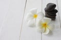 White Plumeria are placed on white wooden floor