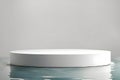 White podium with a round shape, set on the reflective water surface Royalty Free Stock Photo