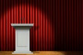 White podium on stage under spotlight over red curtain Royalty Free Stock Photo