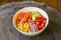 White Poke Bowl with cubes of Norwegian salmon, sweet corn, pieces Royalty Free Stock Photo