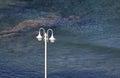 White pole with lights on sea background