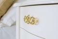 White polished chest of drawers with golden handles. chest of drawers in a classic style. Furniture production, furniture fittings Royalty Free Stock Photo