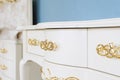 White polished chest of drawers with golden handles. Luxurious chest of drawers in a classic style Royalty Free Stock Photo