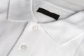 White poloshirt with blank black label