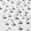 Polystyrene foam balls of varying sizes are scattered on a flat white Royalty Free Stock Photo