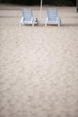 White pool chairs on sand beach Royalty Free Stock Photo