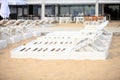 White pool chairs on sand beach Royalty Free Stock Photo