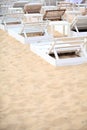 White pool chairs on sand beach Royalty Free Stock Photo