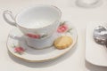 Porcelain antique tea cup with a cookie for afternoon tea Royalty Free Stock Photo