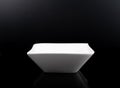 White porcelain bowl isolated in black, space for copy text. Simple, no food or other ingredients