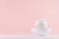 White porcelain bowls pile with thin gold border, different texture in soft light white, pastel pink kitchen interior. Fashion.