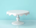 White porcelain cake stand on blue backgroung