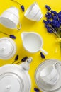 White porcelain coffe or tea set with muscari flowers on yellow Royalty Free Stock Photo