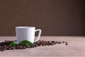 White coffee cup stands on brown surface near scattered coffee beans Royalty Free Stock Photo