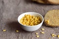 White porcelain corn bowl with corn scattered around