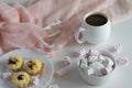 white porcelain cup of black strong hot coffee, tea on a light background with delicate marshmallows and cakes, homemade cakes Royalty Free Stock Photo