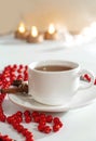 White porcelain cup. Cinnamon stick. Blurred circles bokeh. Red scenery Royalty Free Stock Photo