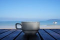 White porcelain cup of coffee on the sea background Royalty Free Stock Photo