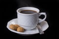 White porcelain cup of coffie with three Italian amaretti cookies