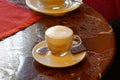 White porcelain Cup with gourmet coffee on marble table in Italian bar.