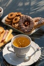 White cup and saucer with light floor, spoon, served outdoors Royalty Free Stock Photo