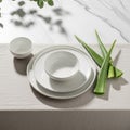 White porcelain dinnerware set includes a cup and two plates, artfully arranged on a textured, Royalty Free Stock Photo