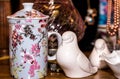 White porcelain doves with japanese inspired cup on a vintage store shelf