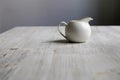 White porcelain gravy boat on a wooden table in the kitchen Royalty Free Stock Photo