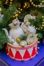 White porcelain mice in a red toy drum. Christmas decorations. Symbol of the year 2020