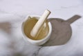 White porcelain mortar and pestle for mixing organic medicine in the pharmacy