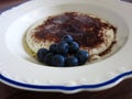 White porcelain plate with  porridge and  blueberriess Royalty Free Stock Photo