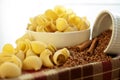 White porcelain plates with dry Snailshell-shaped pasta and buck Royalty Free Stock Photo