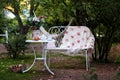 White porcelain set for tea or coffee on table in the garden over blur green nature background. Summer outdoor party Royalty Free Stock Photo