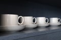 white porcelain teacups and saucers stand on a shelf with a wooden texture in blue-gray close-up Royalty Free Stock Photo