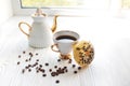 white porcelain teapot and cup on white wooden table on windowsill on sunny day. Tea after game. Chess pieces near Royalty Free Stock Photo