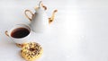 white porcelain teapot and cup on white wooden table on windowsill on sunny day. Tea after game. Chess pieces near Royalty Free Stock Photo