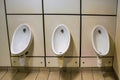White porcelain urinals in men restroom toilet