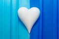 White porcelein heart on double colored blue paper