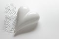 White porcelein heart with paper feather