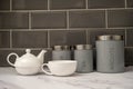 white porcelin china tea pot and cup set on a marble worktop Royalty Free Stock Photo