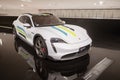 white Porsche Taycan 4S Cross Turismo EV, battery-electric Car in exhibition complex Museum Porsche, history and Innovation in