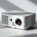 White portable projector with a compact, rectangular design. Features a prominent Royalty Free Stock Photo