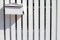 Post box on white wooden fence Royalty Free Stock Photo